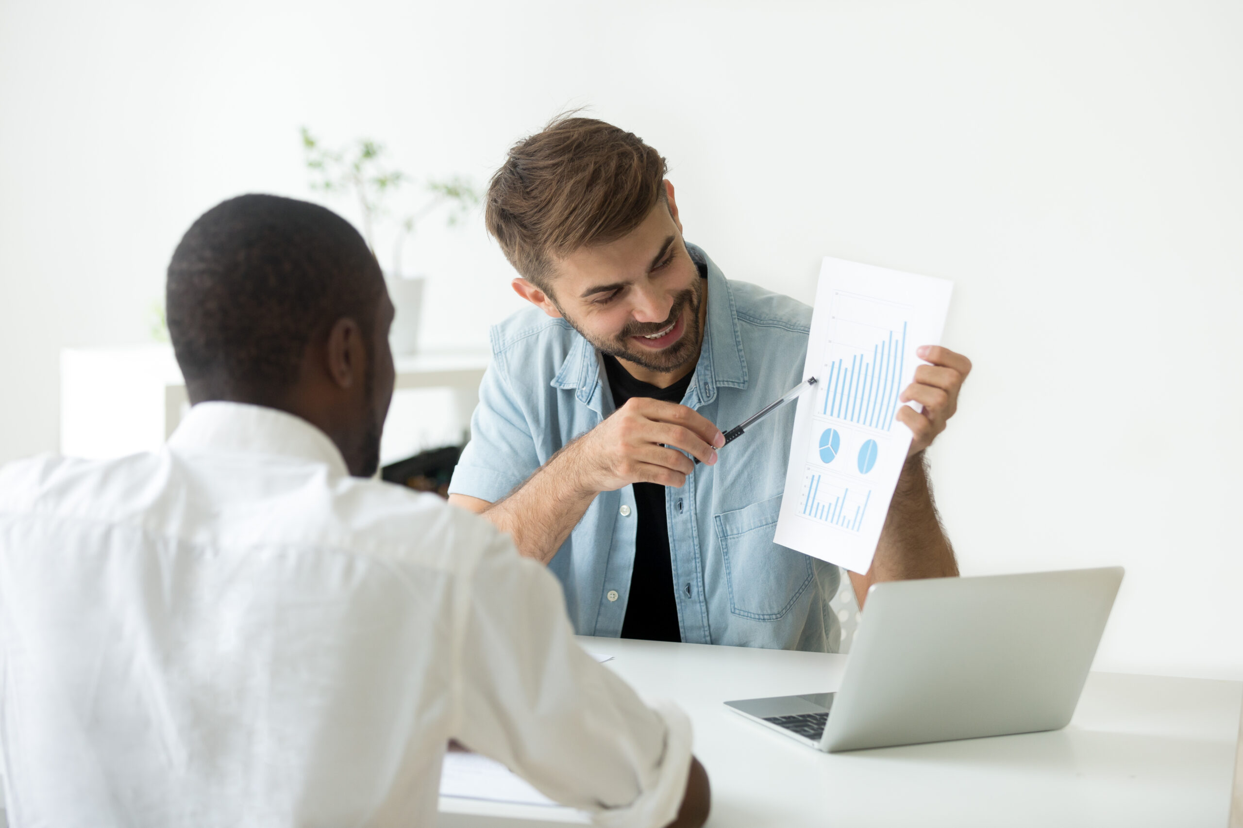 Smiling,Caucasian,Worker,Showing,Visual,Material,To,African,American,Colleague,