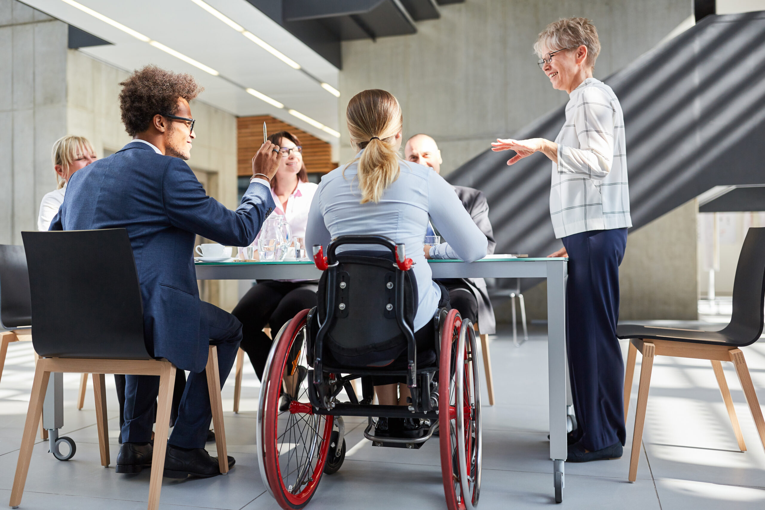 Group,Of,Business,People,In,A,Meeting,With,Colleague,In